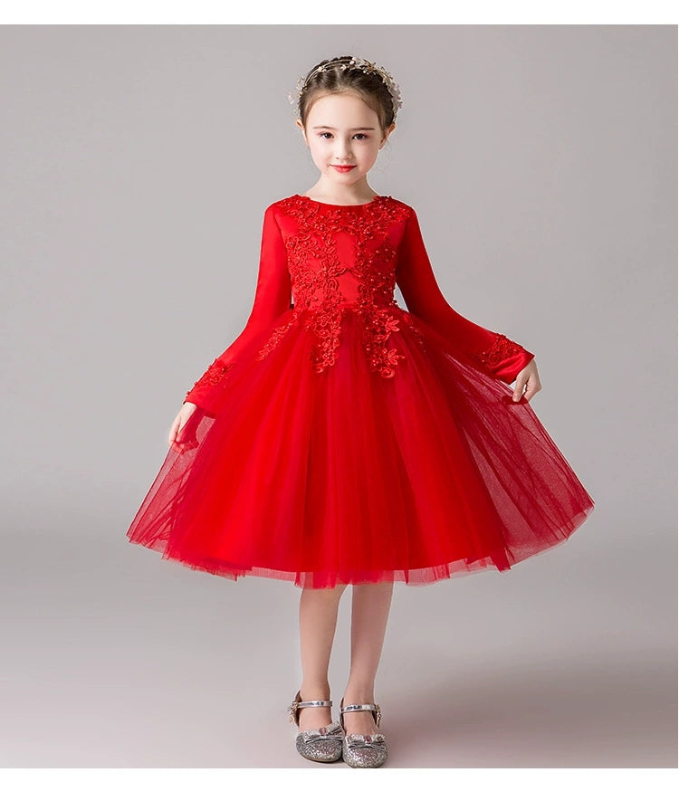 Girl in red long-sleeved tulle dress with floral lace bodice.