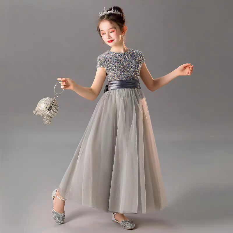 Girl in a gray tulle dress with sequin bodice, sash, crown and handbag.