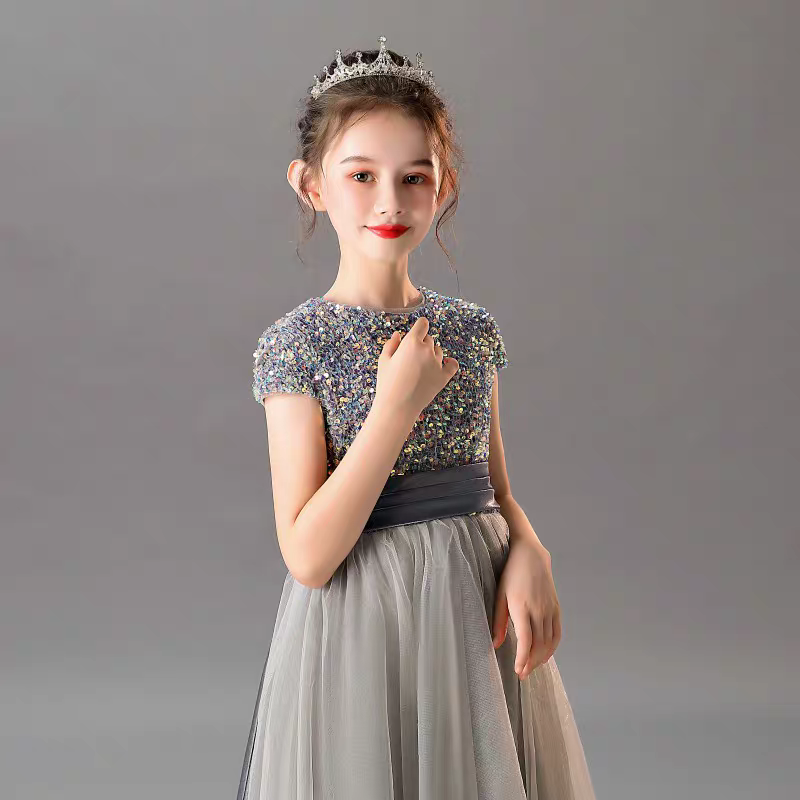 Girl in sequined bodice dress with tulle skirt and tiara.