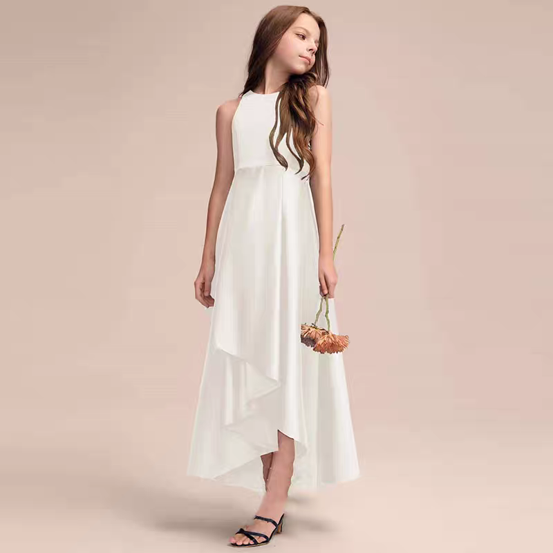 Girl in white halter neck dress with asymmetrical hem, holding a flower. Formal occasion dress.
