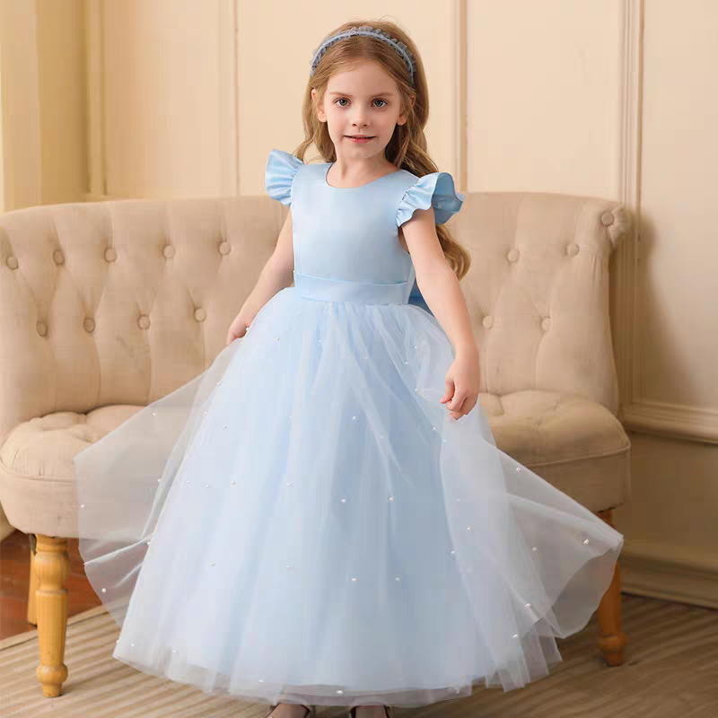 Girl in light blue tulle flower girl dress with pearl accents and matching headband.