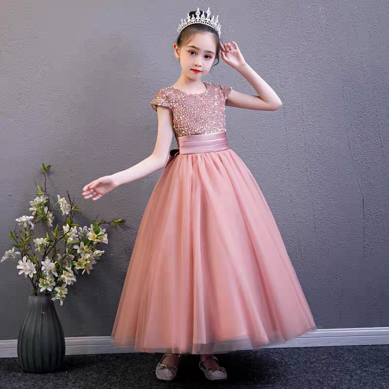 Girl in a pink sequin bodice tulle dress with a crown.