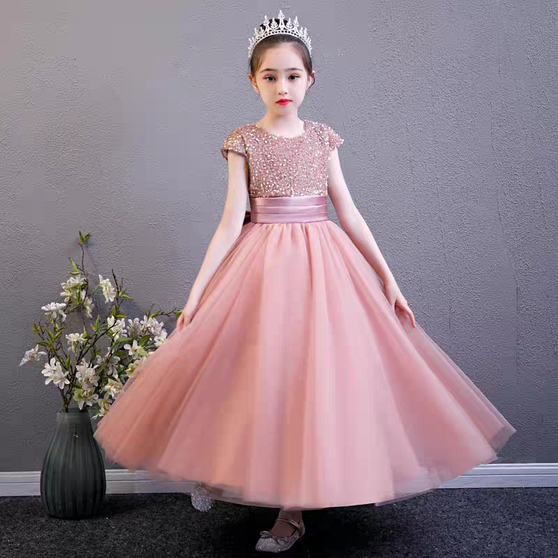 Girl in pink sequin bodice dress with tulle skirt and tiara, perfect for flower girls or special occasions.