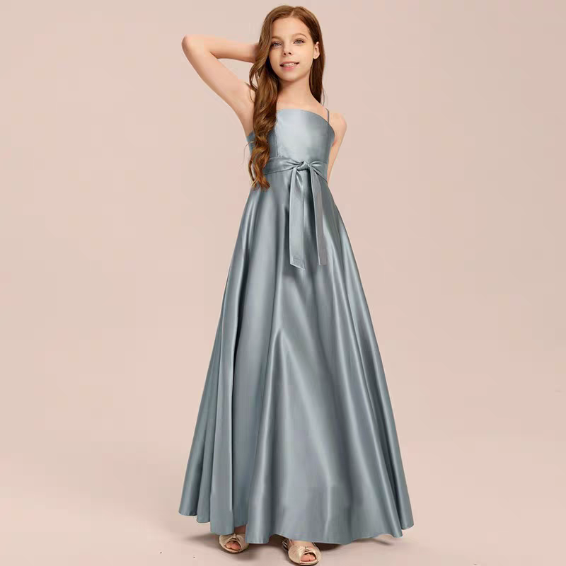 Girl in a silver satin A-line gown with spaghetti straps and a tie waist.