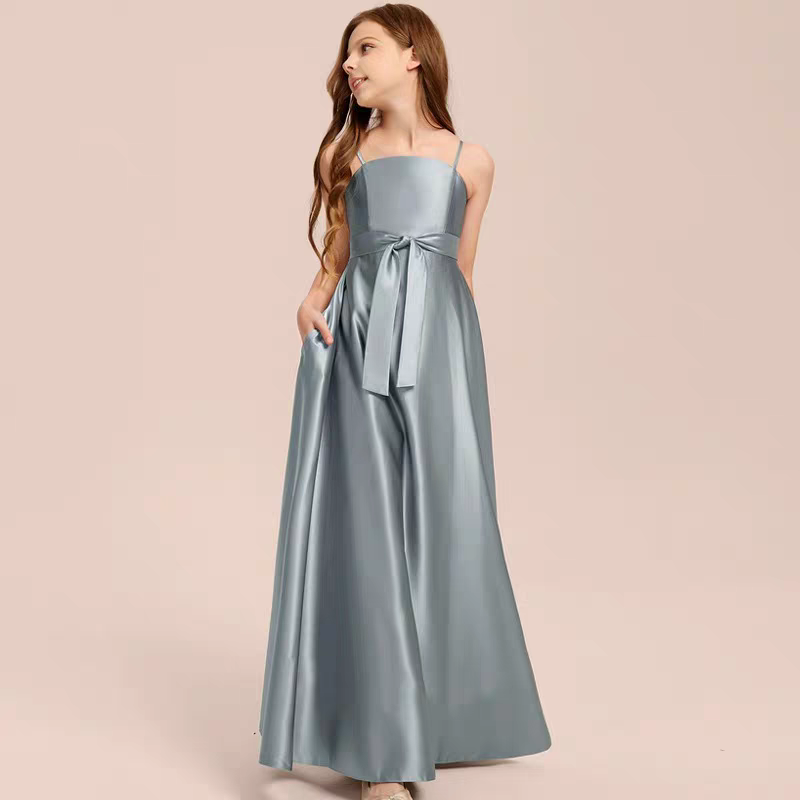 Girl in long blue/gray satin dress with spaghetti straps and tie waist.