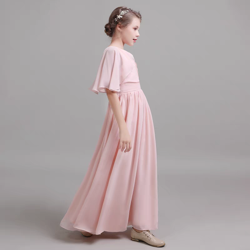 Girl wearing a light pink formal dress with flutter sleeves and a star headband.