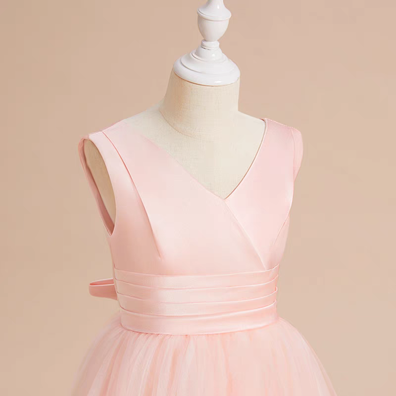 Pink sleeveless V-neck flower girl dress with tulle skirt on a mannequin.