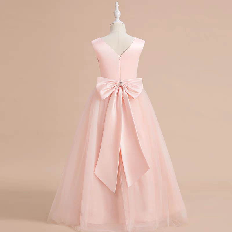 Back view of a pink formal dress with tulle skirt and large satin bow.