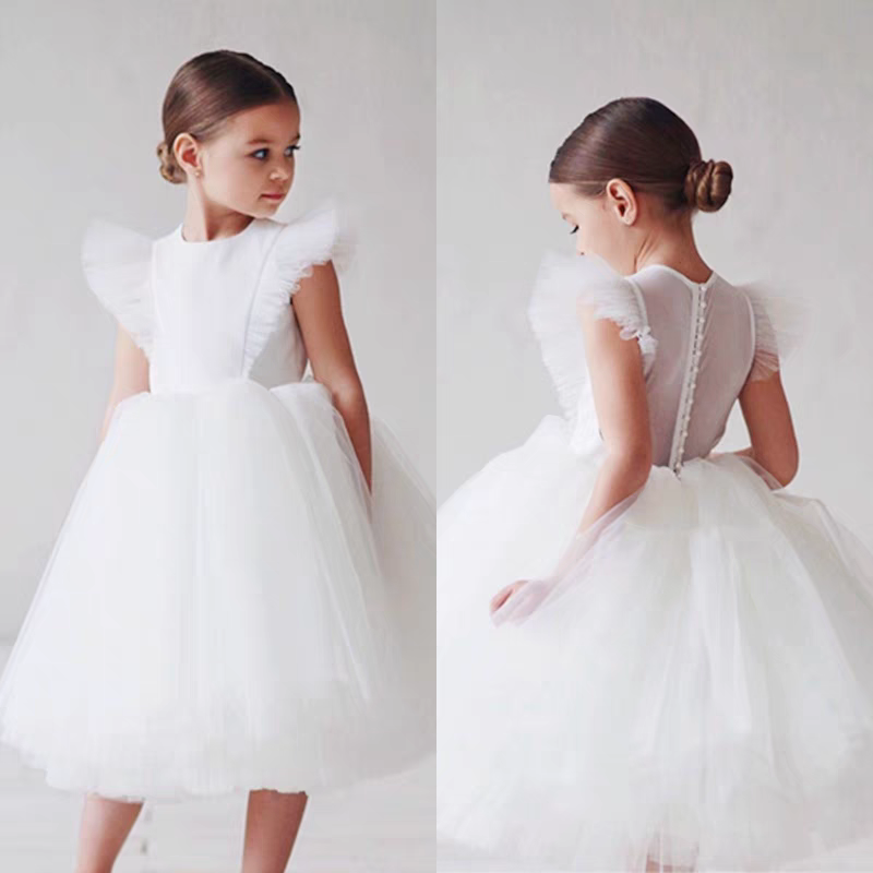 Girl in white tulle flower girl dress with ruffle sleeves, front and back view.