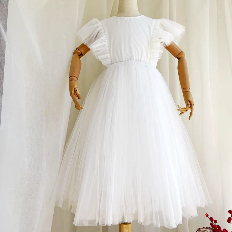 White tulle dress with flutter sleeves on a mannequin.