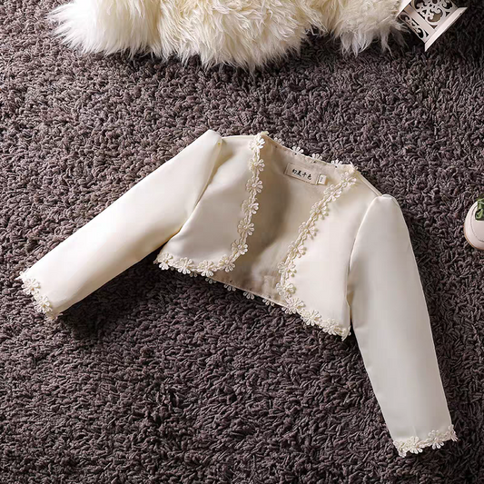 Ivory bolero jacket with floral trim for girls, cropped length, long sleeves.