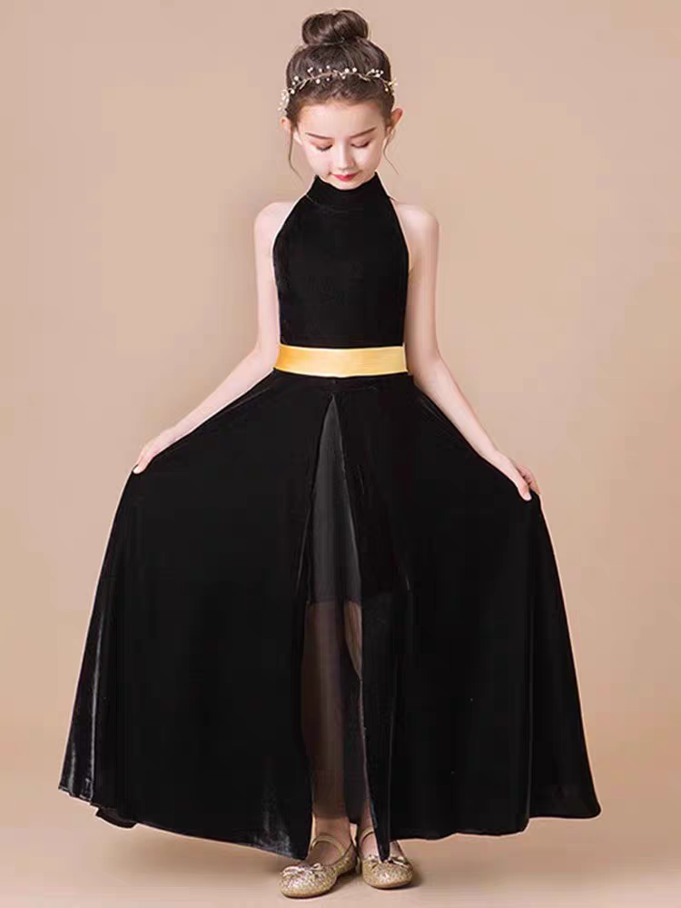 Girl in black halter velvet dress with gold sash and sheer skirt overlay.