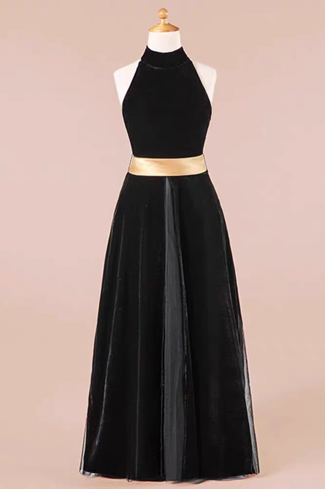 Elegant black velvet halter dress with gold belt on mannequin. Floor-length gown.