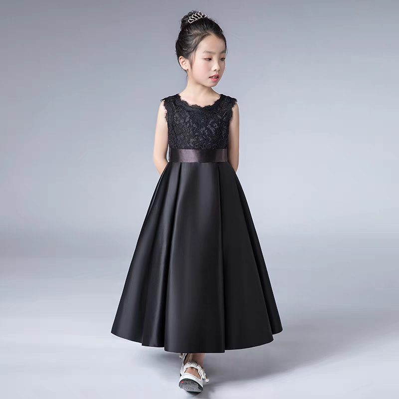 Girl in black lace bodice and satin skirt formal dress with tiara.