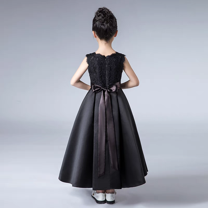 Back view of girl's black dress with lace top and satin skirt with ribbon detail.