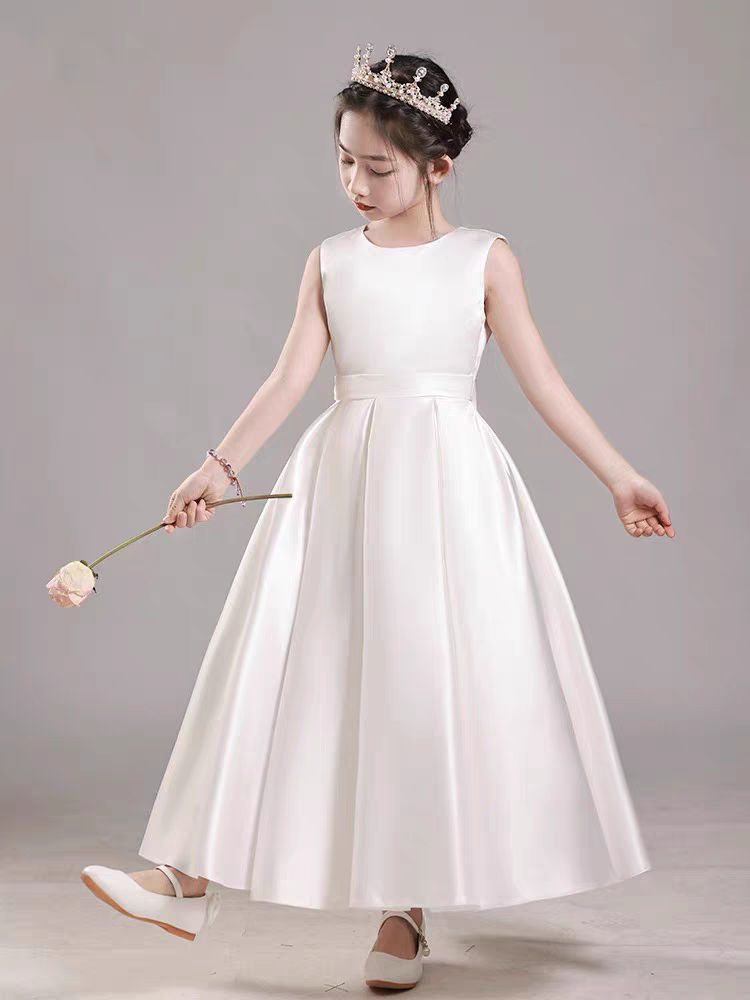 Girl in white satin dress with crown holding rose, perfect for flower girl or special occasion.