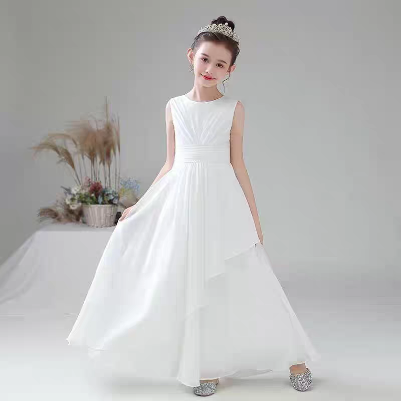 Girl in flowing white formal dress with layered skirt and tiara.