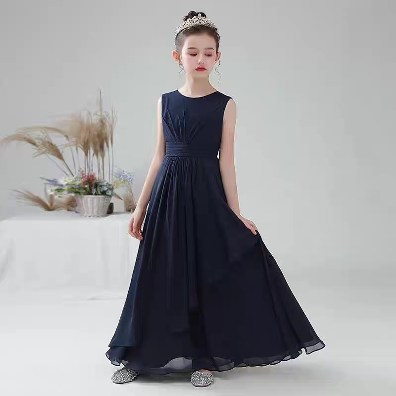 Girl in navy blue chiffon gown with empire waist and jeweled tiara