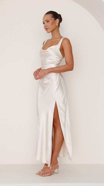 Champagne satin maxi dress with cowl neck and thigh-high slit.