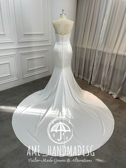 Pure Grace: A Minimalist Satin Mermaid Gown with Buttoned Train