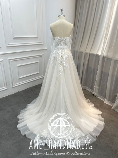 Ethereal Whisper: A Strapless Tulle Bridal Gown with Floral Lace