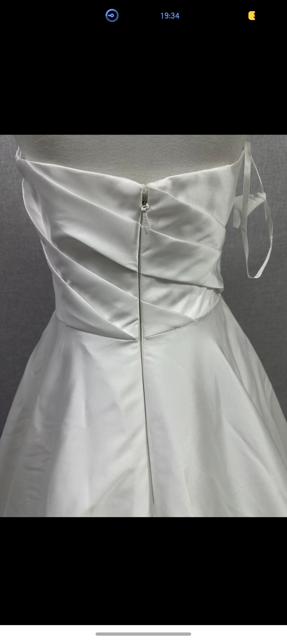 Original reference photograph of strapless pleated off-white Mikado satin wedding gown, back bodice and zipper close-up.
